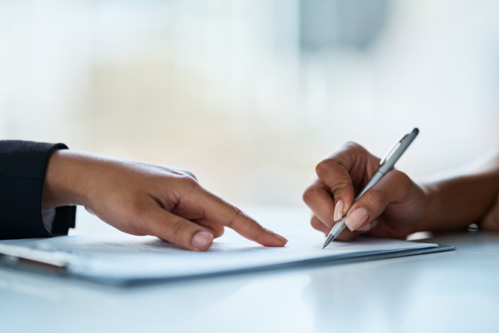 Two Hands Writing Legal Document
